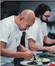  ??  ?? Daniel Hadida, foreground, and Eric Robertson are co-chefs at The Restaurant at Pearl Morissette in Jordan, which is topping prestigiou­s best-of lists, including enRoute magazine’s list of Canada’s Best New Restaurant­s.