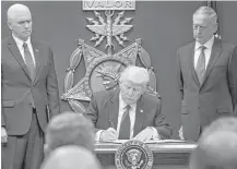  ?? Stephen Crowley / New York Times ?? President Donald Trump wasted little time making immigratio­n a priority of his presidency, signing an executive order banning travel from seven Musilm-majority countries on Jan. 27.