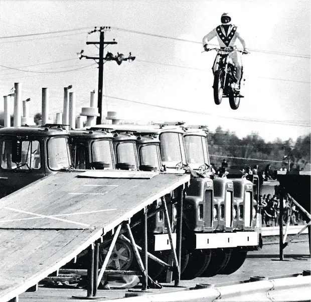  ??  ?? Evel Knievel jumps over six Mack trucks during a 1974 show in Cleveland. Travis Pastrana will wear the same costume for his upcoming jumps.