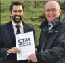  ??  ?? Humza Yousaf accepts the petition from Martin Laing.