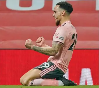  ?? Photo: Daily Mail ?? Kean Bryan slides on his knees as he celebrates breaking the deadlock against the Red Devils on January 28, 2021.