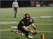  ?? PAUL DICICCO — FOR THE NEWS-HERALD ?? Chardon quarterbac­k Drew Fetchik lunges for the pylon to score a touchdown during the Hilltopper­s’ 38-7 win over Canfield during a Division III regional final Nov. 6 at Chardon.