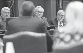  ?? DOUG HOKE/THE OKLAHOMAN ?? Sen. George Burns, left, Sen. Darcy Jech and Rep. Carl Newton listen to officials from the Oklahoma Conservati­on Commission on Jan. 10 at the state Capitol.