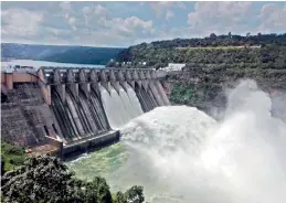  ??  ?? Four crest gates of Srisailam dam was opened on Sunday after water in the reservoir recorded 884.80 feet against the total reservoir height of 885 feet.