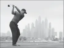  ?? WARREN LITTLE, GETTY IMAGES ?? Tiger Woods tees off on the eighth hole during the first round of the Omega Dubai Desert Classic at Emirates Golf Club on Thursday.