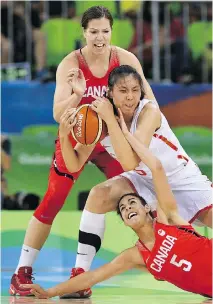  ?? SEAN KILPATRICK/THE CANADIAN PRESS ?? Katherine Plouffe, top, and Canadian teammate Kia Nurse defend against China’s Nan Chen on Saturday.