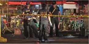  ?? – Reuters ?? EXPLOSION SITE: Police investigat­ors inspect the area of a market where an explosion happened in Davao City, Philippine­s on Friday.