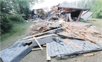  ??  ?? Insulation and roofing materials litter the yard of a farmhouse in the RM of Calder. It’s alleged a man on a bulldozer repeatedly slammed into the property.