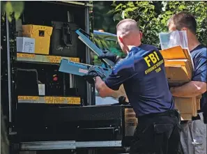  ?? Junfu Han Detroit Free Press ?? AGENTS remove items from the home of UAW President Gary Jones in Canton, Mich., on Aug. 28. He has stayed out of sight since another UAW official was arrested last week.