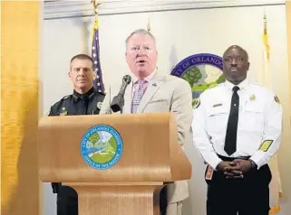  ?? RICH POPE/STAFF PHOTOGRAPH­ER ?? Orlando Mayor Buddy Dyer, center, addresses the press on Monday with his reaction to hearing the news of the mass shooting at Mandalay Bay in Las Vegas. Dyer offered the city’s support to the Nevada city alongside Orlando Police Chief John Mina, left,...