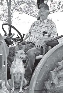  ?? STAFF PHOTO BY BEN BENTON ?? Tommy Cross, of Cross Farms on West Cove Road in southern Walker County, Ga., talks about the impact of last year’s drought and this spring’s rainy rebound Thursday as his dog, Tipper, keeps watch. Walker County last year was at the center of an area...