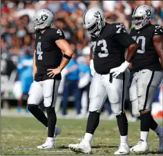  ?? NHAT V. MEYER/TRIBUNE NEWS SERVICE ?? Raiders quarterbac­k Derek Carr (4) walks off the field after throwing an intercepti­on against the Chargers on Sunday at the Coliseum in Oakland.