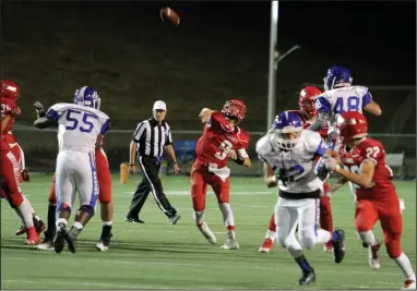  ?? DAVID WITTE/NEWS-SENTINEL ?? Lodi quarterbac­k Logan Stout launches the ball downfield for one of his three pass attempts during the Flames' victory over Bear Creek on Friday at the Grape Bowl.