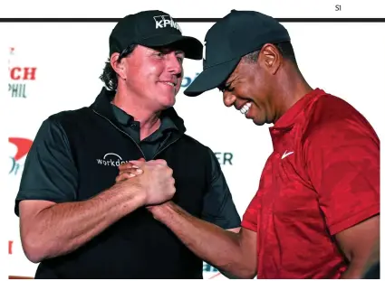  ??  ?? May the best man win: Phil Mickelson and Tiger Woods shake hands ahead of ‘The Match’