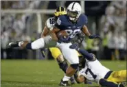  ?? THE ASSOCIATED PRESS FILE ?? Penn State’s Saquon Barkley (26) makes a move on Michigan’s Khaleke Hudson (7) during the first half in State College, Pa. on Oct. 21.