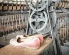  ?? CUMBERLAND TIMES-NEWS ?? When the Klotz silk mill in Lonaconing was abandoned, equipment and personal effects like these shoes were left behind, and the factory has remained largely untouched since.