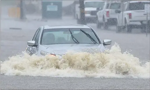  ?? PETE BANNAN - MEDIANEWS GROUP ?? This motorist soon became stuck trying to drive through floodwater­s on Haverford Road on Tuesday.