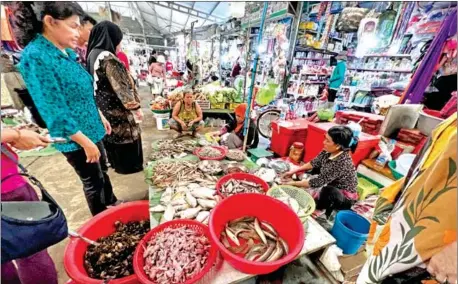  ?? HONG MENEA ?? Meat vendors at their stalls in a Phnom Penh market in January 2023.