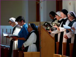  ??  ?? The Sisters take part in the Office of Sext, the fourth liturgical prayer of the day