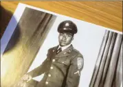  ?? ALYSSA POINTER / ALYSSA.POINTER@AJC.COM ?? An old photograph of buffalo soldier Harold S. Cole when he enlisted in the Army at the age of 17 sits on a desk at his Cobb County residence. Cole is one of a few living buffalo soldiers in the United States. Cole served in the U.S. Army from 1942 to 1946. He retired from the military after 22 years of service.