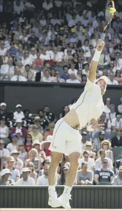  ??  ?? Andy Murray fires down a serve against Mikhail Kukushkin at a sun-baked Wimbledon yesterday where