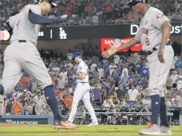  ?? Robert Gauthier Los Angeles Times ?? GEORGE SPRINGER of the Houston Astros, left, is congratula­ted by third base coach Gary Pettis after hitting a two-run homer against Dodgers reliever Brandon McCarthy, background, in the 11th inning.