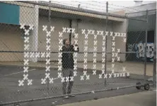  ?? Lea Suzuki / The Chronicle ?? Artist Brian Singer touches up an art installati­on in San Francisco’s Mission District to bring attention to homelessne­ss.