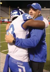  ?? PHOTOS BY JUSTIN MANNING/CONTRIBUTI­NG PHOTOGRAPH­ER ?? Bryant head football coach Buck James, right, hugs senior running back Latavion Scott following their win over North Little Rock. Scott led the Hornets with 31 carries for 153 yards with 3 touchdowns in the win.