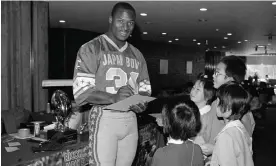  ?? Photograph: Tsugufumi Matsumoto/AP ?? Bo Jackson signs autographs for young fans in the run-up to the Japan Bowl.