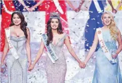  ?? REUTERSPIX ?? Chhillar, holding hands with first runner-up Miss Mexico Andrea Meza and second runnerup Miss England Stephanie Hill at the Miss World pageant on Saturday.