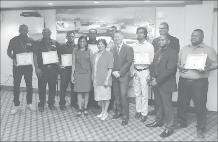  ??  ?? High Commission­er of Canada to Guyana Lilian Chatterjee (middle) along with CEO of Safework Solutions Jeff Daniels (third from right front row) and Dr. Surendra Persaud right in the back row) along with the graduating students last evening.