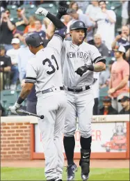  ?? Rob Carr / Getty Images ?? The Yankees’ Gary Sanchez celebrates with Aaron Hicks (31) after hitting a three-run home run in the first inning at Baltimore’s Oriole Park at Camden Yards on Tuesday.