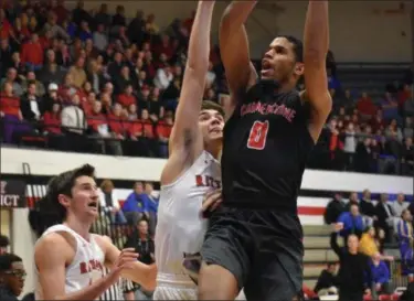  ?? DEANDRE’ PATRICK — THE NEWS-HERALD ?? Cornerston­e’s Kendall Saunders drives to the basket against Rittman on March 13 during a Division IV regional semifinal at Canton Fieldhouse.