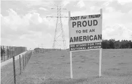  ?? COURTESY OF ELAINE SIMMONS ?? Elaine Simmons’ sign supporting President Donald Trump stood nearly a year on her property along North Hancock Road near Minneola, but it was brought to Lake County officials’ attention after she added “We stand for the national anthem.” She said she...