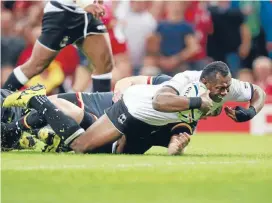  ?? PHOTO: GETTY IMAGES ?? Vereniki Goneva of Fiji scores their only try during the Rugby World Cup Pool A match between Wales and Fiji at the Millennium Stadium today.