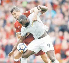  ?? — Reuters photo ?? Manchester United’s Romelu Lukaku is challenged by Liverpool’s Dejan Lovren during the Premier League match at Anfield, in this Oct 14 file photo.