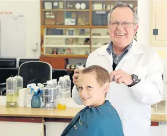  ?? Picture: BRIAN WITBOOI ?? IN THE POUND SEAT: Johan Senekal cuts the hair of a young customer