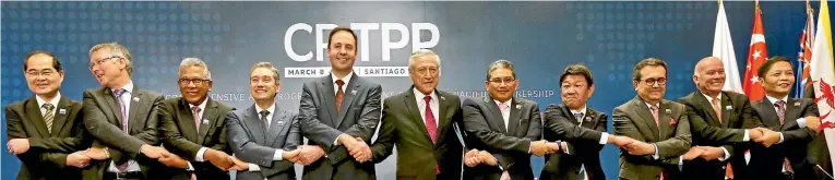  ?? PHOTO: AP ?? David Parker, second from left, at the signing in Santiago of the CPTPP. Parker says the absence of protest in New Zealand shows Labour has built a consensus on trade.