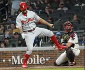  ?? JOHN AMIS — THE ASSOCIATED PRESS ?? The Phillies’ Henderson Alvarez loses his balance after swinging at a pitch as Atlanta catcher Tyler Flowers, right, looks on during the fifth inning.