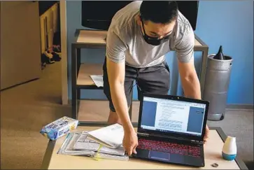  ?? Josie Norris Los Angeles Times ?? ETHAN RECINTO, a junior studying internatio­nal relations at USC, gets ready for his Japanese class in his apartment at the University Gateway complex, which has been a popular location for parties.