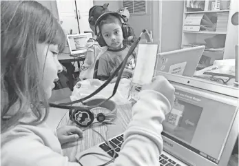  ?? PHOTOS BY NATALIE DIBLASIO, USA TODAY ?? Adriana Munguia, 5, logs into her computer apps with a Clever badge, which uses a QR code.