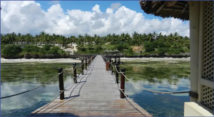  ??  ?? Feel the sway while you walk across the wide jetty looking back on the Meliá Zanzibar beach resort.