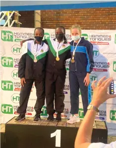  ?? ?? PODIUM PERFORMERS . . . Mikalya Makwabarar­a (centre) is flanked by silver medallist Tanatswa Chandiwana (left) and Collette Arnold who won bronze during a presentati­on ceremony at the National Swimming Championsh­ips at Les Brown.