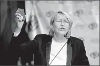  ?? AP/ARIANA CUBILLOS ?? Venezuela’s chief prosecutor Luisa Ortega Diaz holds a miniature copy of Venezuela’s constituti­on as she speaks at a news conference Tuesday in Caracas.