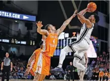  ?? AP PHOTO/WADE PAYNE ?? Vanderbilt guard Tyrin Lawrence shoots over Tennessee’s Tyreke Key on Wednesday night in Nashville. Vanderbilt won 66-65.