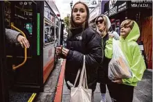  ?? Stephen Lam/The Chronicle ?? Yana, 13, looks for a bus in S.F. The eighth-grader has been subject to bullying in school after fleeing Ukraine with her mother.