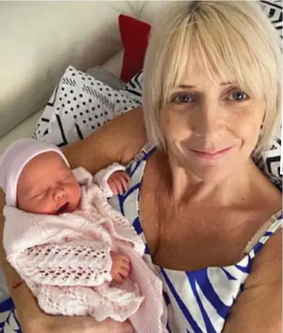  ?? ?? Bundle of joy: Beaming with delight, Ms Dalglish cradles her newborn daughter Daisy Grace