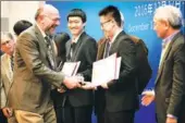  ?? PROVIDED TO CHINA DAILY ?? Sam Bader of Argonne National Lab presents awards to young winners at the Dongrun-Yau Science Award.