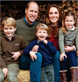  ??  ?? ALL SMILES: The Cambridges’ card with George, Louis and Charlotte