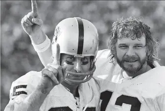  ?? Associated Press 1977 ?? The Raiders finally won a title in Super Bowl XI on Jan. 9, 1977, in Pasadena when Oakland beat Minnesota 3214. Receiver Fred Biletnikof­f (left) and quarterbac­k Ken Stabler celebrate.